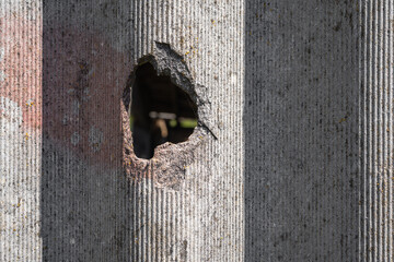Old and very dangerous asbestos roof. Asbestos dust in the environment. Asbestos removal