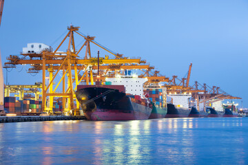 Gantry crane or crane port working with cargo container on large cargo ship at front view in...