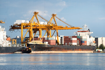 Large crane and cargo ship transport cargo container and docked at port in Bangkok of Thailand....