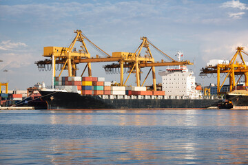 Large crane and cargo ship transport cargo container and docked at port in Bangkok of Thailand. Business industry of shipping, logistics, international global trade, freight transport, import export.