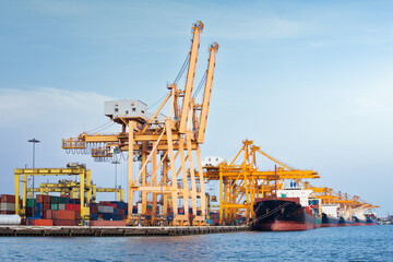 Large crane and cargo ship transport cargo container and docked at port in Bangkok of Thailand....