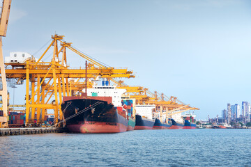Large crane and cargo ship transport cargo container and docked at port in Bangkok of Thailand....