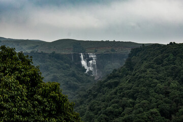 Dainthlen waterfall of Meghalaya, a Majestic multi-tiered waterfall cascading through dense forest,...