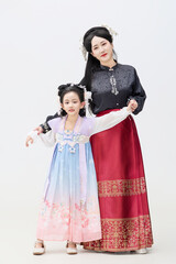 Portrait of Chinese mother and daughter dressed in Hanfu costumes on black background