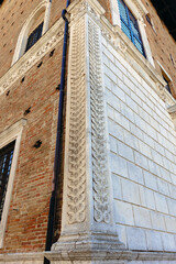 Historical detail of Renaissance architecture in the center of medieval Urbino, showing intricate stone and brick patterns