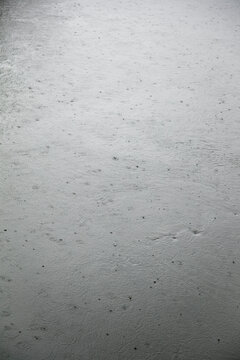 Raindrops hitting large body of water