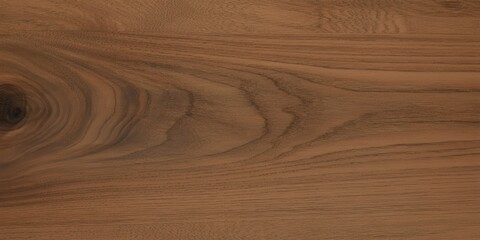 Naklejka premium Smooth polished walnut wood surface showcasing natural grain patterns and warm brown tones. The elegant swirls and linear textures highlight the organic beauty of this premium hardwood material.