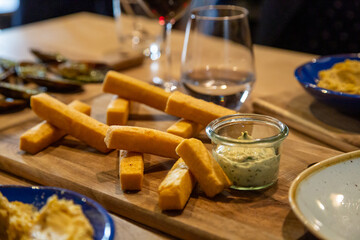 Panisses and aioli, culinary specialty of Marseille, south of France, on a wooden board