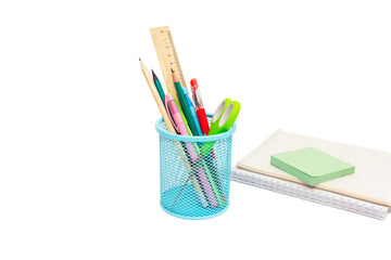 School and office supplies, pens, pencils, ruler, compass in a metal cup on a white background.