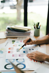 Portrait of a man working with documents using laptop in modern office. Preparing accounting analysis report, real estate investment information, finance and tax concept.