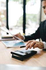 Close-up of hands working with computer tablet in modern office. Preparing accounting analysis report, real estate investment information, financial and tax system concept.