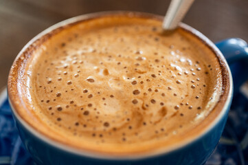 Close up of the surface of hot latte coffee. A latte is a coffee drink made with espresso and steamed milk.