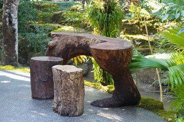 Obraz premium Tree stump chair in the garden