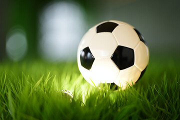Fototapeta premium Soccer ball on grass field close up view sports equipment game and recreation