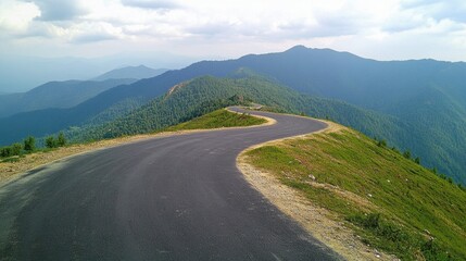 Naklejka premium Winding Mountain Road Through Lush Green Hills.