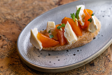 Gourmet Crostini with Brie Cheese, Persimmon, and Pine Nuts