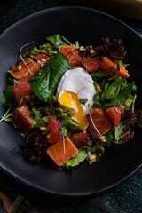 Fresh Salad with Poached Egg and Smoked Salmon in a Gourmet Setting