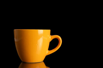 One ceramic cup, close-up, isolated on black background.