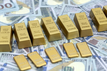 Gold bars and cash are arranged on background of scattered currency, symbolizing wealth and financial security. image conveys sense of prosperity and investment potential