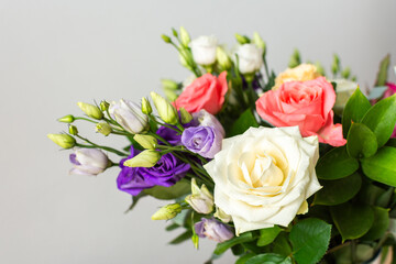 Celebrate special occasions with a colorful summer bouquet featuring fresh roses, eucalyptus, and eustoma blooms, creating an elegant and fragrant floral arrangement