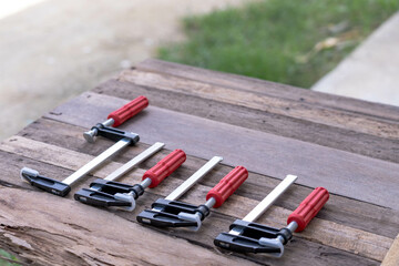 Set of F-Clamps on Wooden Surface – Hand Tools for Woodworking and DIY Projects