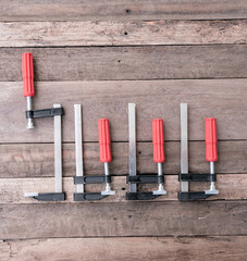 Set of F-Clamps on Wooden Surface – Hand Tools for Woodworking and DIY Projects
