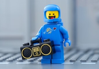 Obraz premium Tambov, Russian Federation - May 30, 2025 Portrait of a Lego astronaut minifigure holding a boombox.