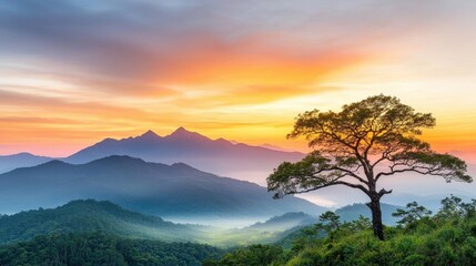 the vibrant hues of orange, pink, and purple spread across the sky like a watercolor painting, casting a warm glow over the rugged peaks of the mountains and the lush sea of green below