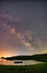 The Milky Way glows brilliantly over the still waters of Lake Kerkini, Greece