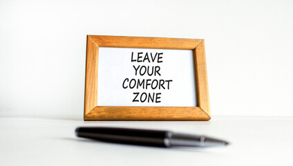 Leave your comfort zone symbol. Concept words Leave your comfort zone on beautiful wooden picture frame. Beautiful white background. Business psychological Leave your comfort zone concept. Copy space.