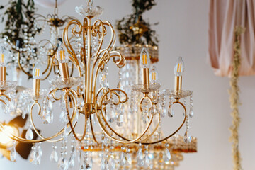 Elegant crystal chandelier hangs in a beautifully decorated indoor venue