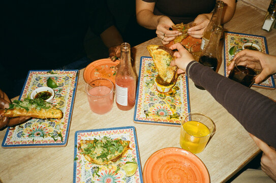 High angle view of friends enjoying fast food at restaurant