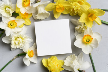 Square greeting card mockup with yellow daffodils flowers, blank paper card mock up with copy space