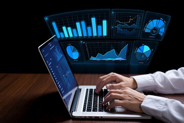 Analyzing data with laptop displaying futuristic blue charts and graphs on black background