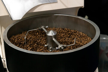 Roasting coffee beans in a modern roaster at a local artisan café
