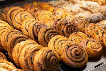 Assorted pastries displayed in a bakery showcase during morning hours