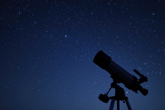 telescope silhouetted against starry night sky captures serene vastness of cosmos