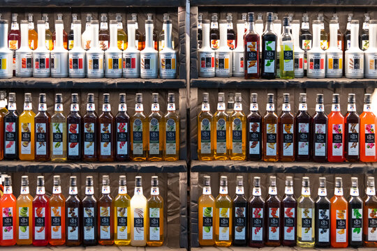 Russia, Moscow - October 07, 2021: Front view of colorful display of flavored 1883 Maison Routin syrups in a bar setting during daytime. Illustrative editorial. Copy space.