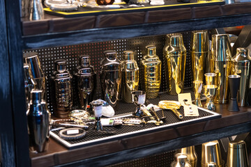 Various cocktail tools display in a stylish bar setting during evening hours