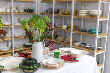 Decorative dining table display with tableware and floral arrangement