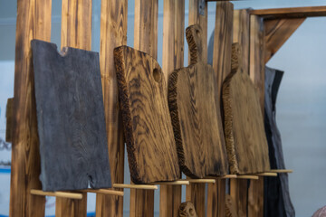 Craftsmanship shines in wooden cutting boards displayed in a workshop