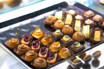 Delicious assortment of desserts displayed on a tray in a bakery