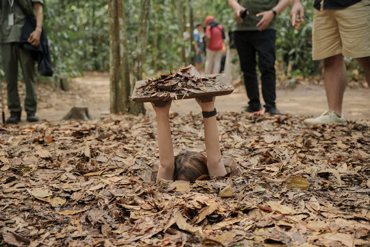 Cu Chi Tunnels. Tourists try to enter the underground tunnels. These tunnels were used in the Vietnam war. Famous tourist attractions in Vietnam