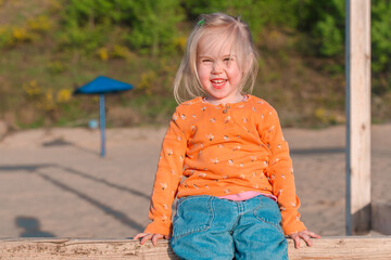 Cute little child on a sandy beach with a beautiful landscape
