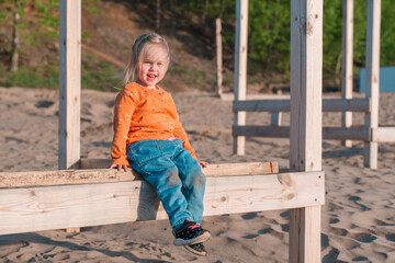 Cute little child on a sandy beach with a beautiful landscape