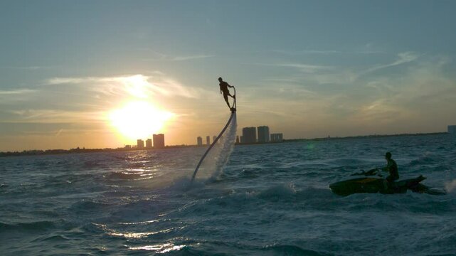 Majestic and cinematic silhouette of water hoverboard soaring through the air in super slow motion at 1000 FPS