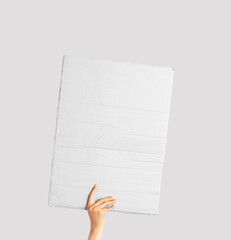 Poster made of white cardboard in his hand. Isolated on white. Set. Copy space. Handheld cardboard cutout on white background. © Luqman Aditiamala