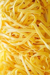 Closeup of Homemade Fresh pasta Tagliatelle, texture background	
