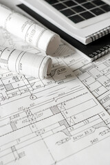 sustainable architecture tools and materials: blueprints, solar panel, wood textures, fabric swatches, and stones. Eco-friendly design, conscious construction and green innovation.