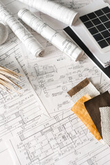 sustainable architecture tools and materials: blueprints, solar panel, wood textures, fabric swatches, and stones. Eco-friendly design, conscious construction and green innovation.